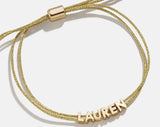 BaubleBar Custom Cord Bracelet - Gold -
Custom nameplate bracelet