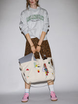 BaubleBar Natural -
Hand select 6 icons to personalize your tote