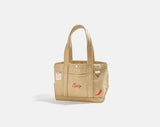 BaubleBar Beige -
Hand select 4 icons to personalize your tote