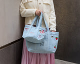 BaubleBar Light Denim -
Hand select 4 icons to personalize your tote