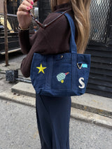 BaubleBar -
Hand select 4 icons to personalize your tote