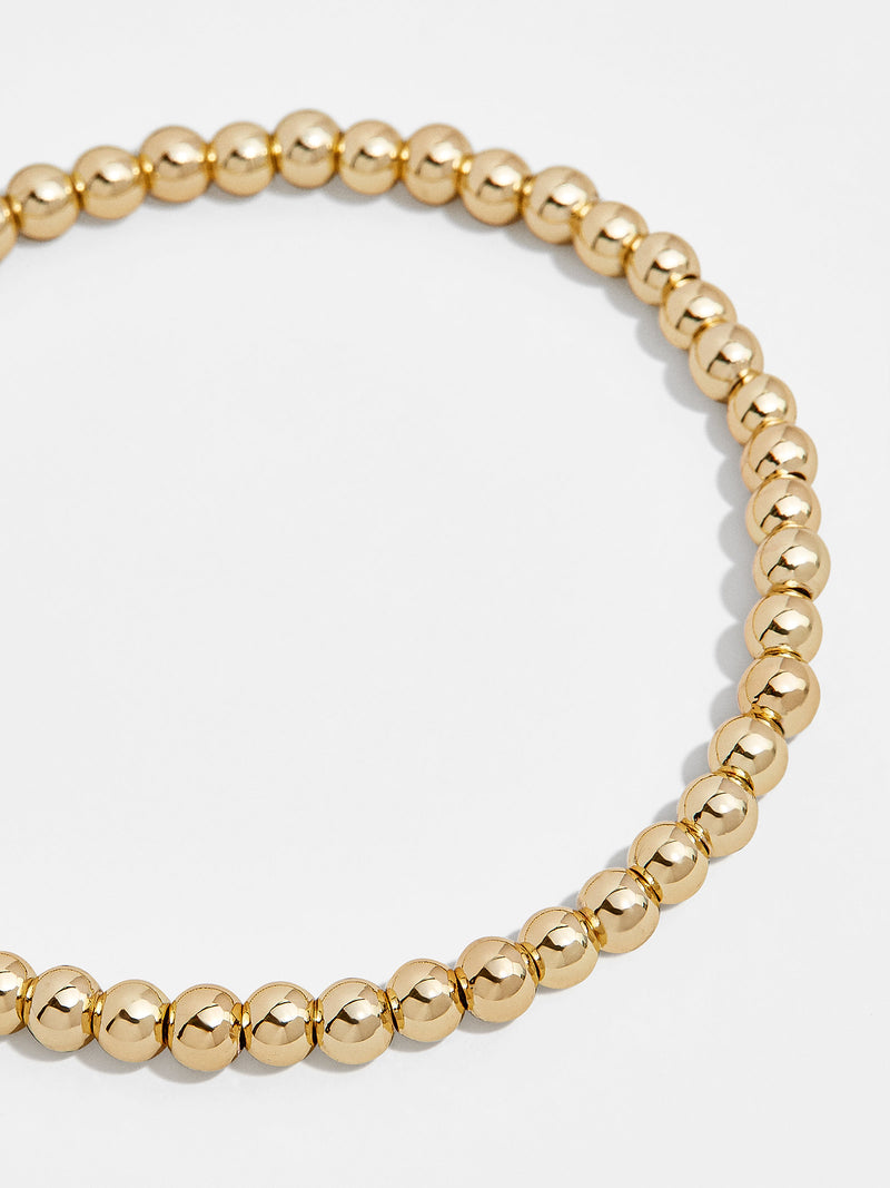 BaubleBar 4MM - 
    Gold beaded stretch bracelet
  
