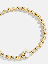 BaubleBar White - Disney gold beaded stretch bracelet