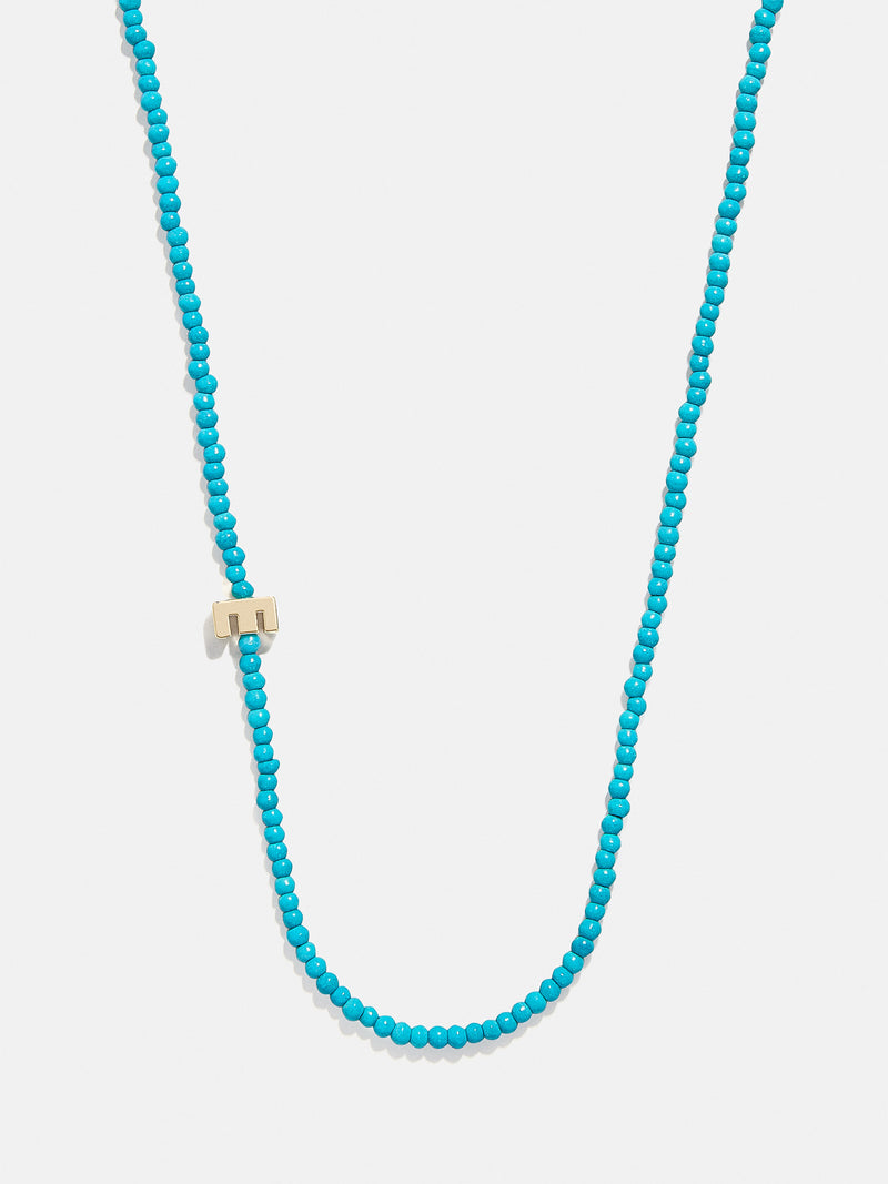 BaubleBar E - 
    Asymmetrical beaded initial necklace
  
