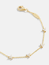 BaubleBar Sadira 18K Gold Bracelet - Flower Trio - 
    18K Gold Plated Sterling Silver, Cubic Zirconia stones
  
