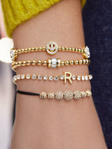 BaubleBar Divine Energy Pisa Bracelet - Smiley Face - 
    Motif stretch bracelet
  
