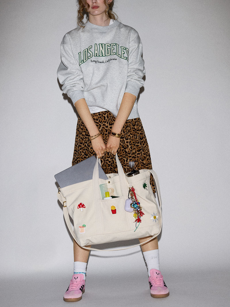 BaubleBar  - 
    Hand select 6 icons to personalize your tote
  
