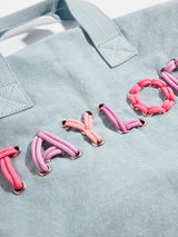 BaubleBar Thready to Go Kids’ Custom Duffle - Light Denim/Pink Multi - 
    Personalized travel bag 
  
