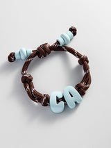 BaubleBar Knotty Enamel Initial Custom Bracelet - Brown/Blue Double Letter - 
    Personalized letter bracelet

  
