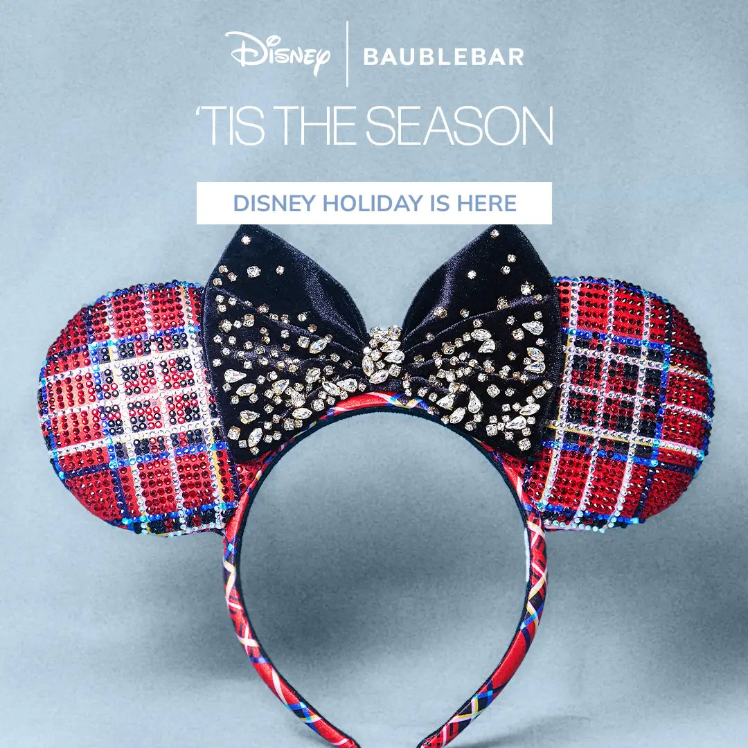 Disney | BaubleBar red plaid crystal ear headband with a jeweled black velvet bow. Text reads “’Tis the season.” Button: “Disney Holiday Is Here.”