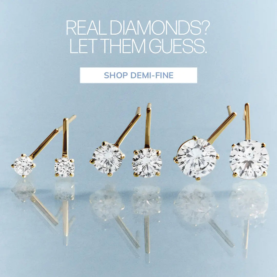 Three pairs of gold stud earrings with round clear stones in graduated sizes. Text reads “Real diamonds? Let them guess.” Button: “Shop Demi-Fine.”