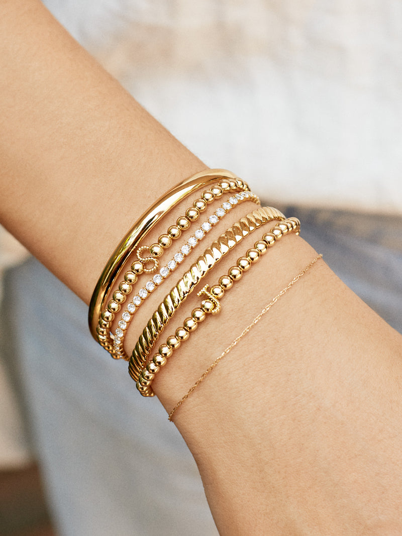 BaubleBar Initial Pisa Bracelet - Gold Twist - 
    Gold beaded stretch bracelet
  
